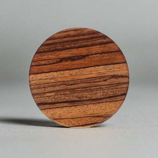 Wooden coaster with a striped pattern on a gray background